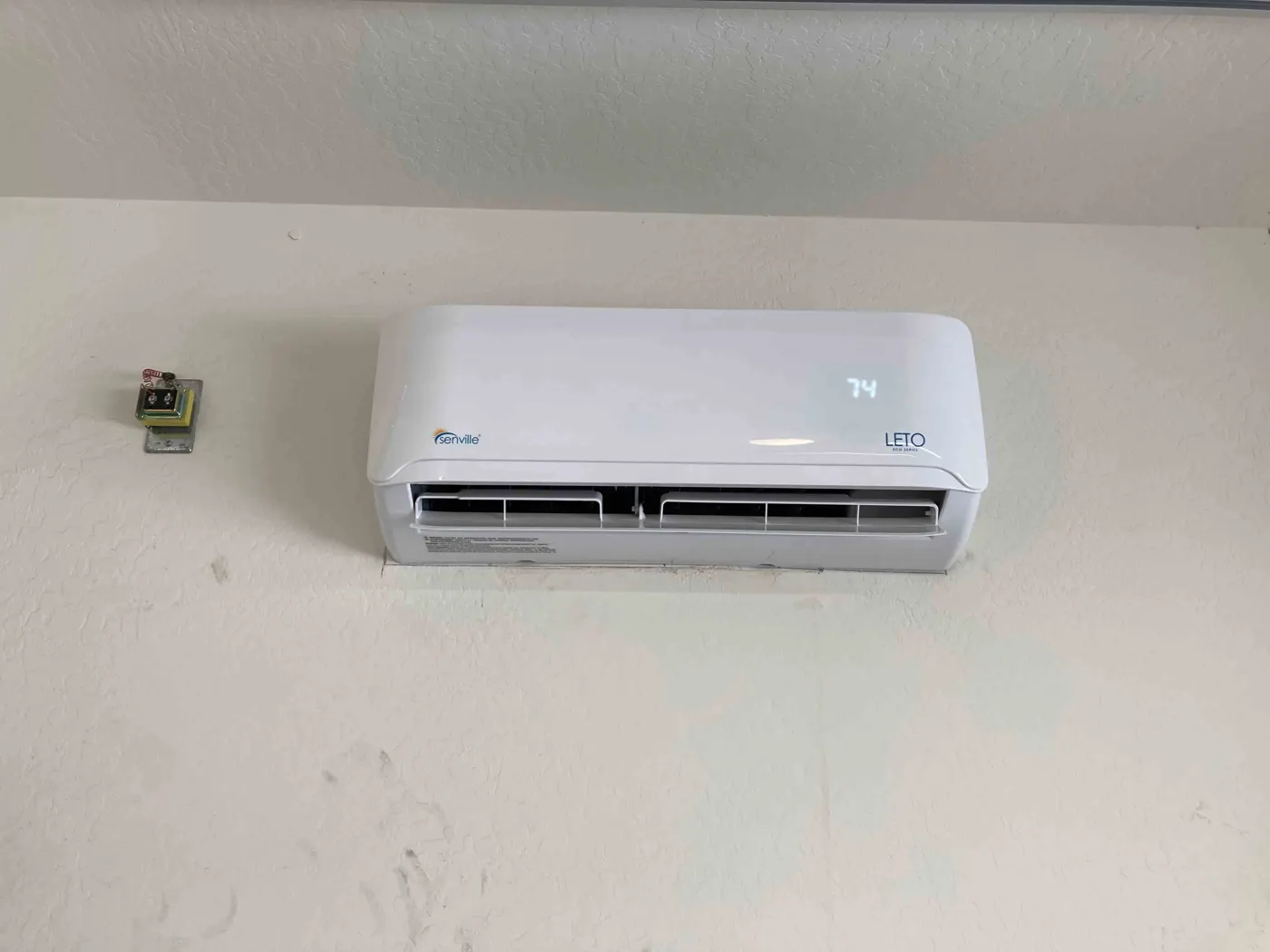Finished ductless mini split indoor unit mounted on a wall