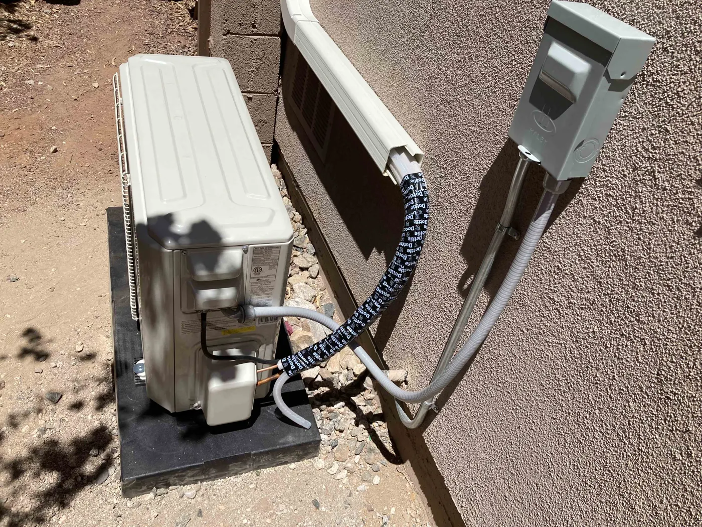 Mini split outdoor unit with line set cover and disconnect
